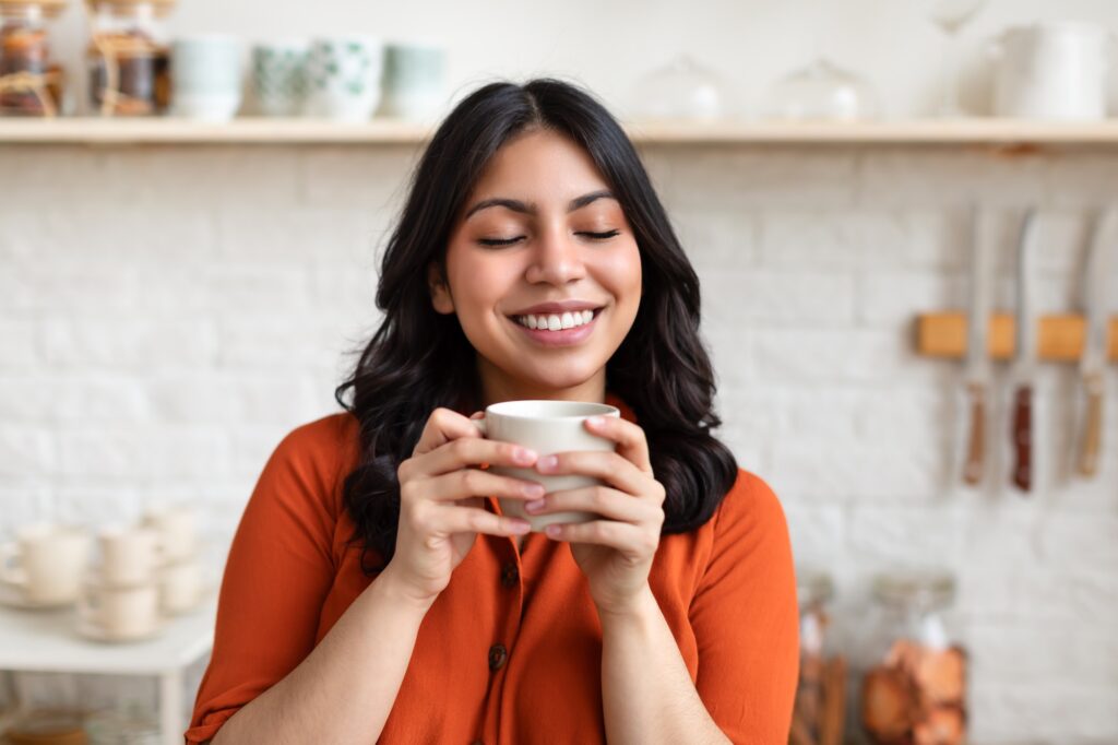 Smiling woman enjoying a cup of coffee